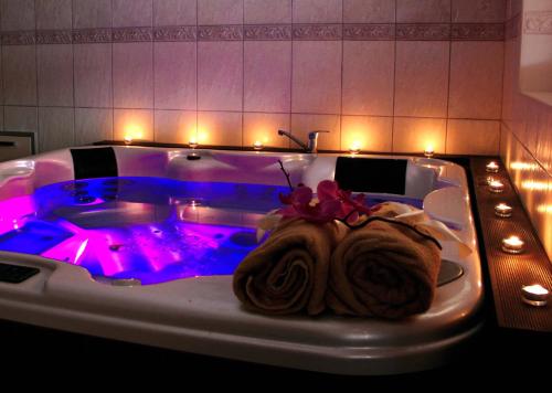 a bath tub with purple lights in a bathroom at Penzion Dori in Diakovce