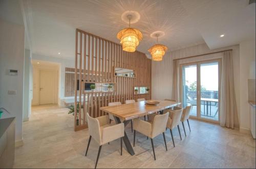 - une salle à manger avec une table et des chaises en bois dans l'établissement Lustica Bay Marina Studio****, à Radovići