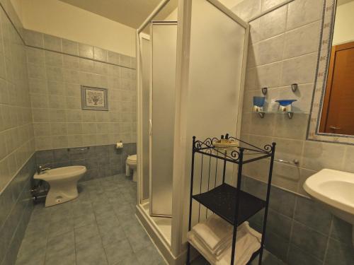 a bathroom with a shower and a toilet and a sink at Residence Le Meridiane in Siena