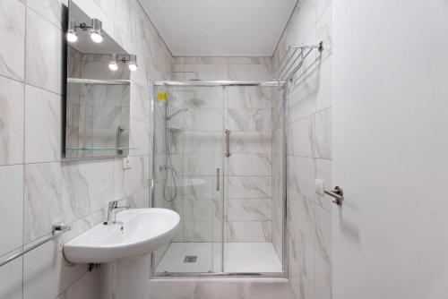 a white bathroom with a shower and a sink at La Tablada Atlantic Sea View in Adeje