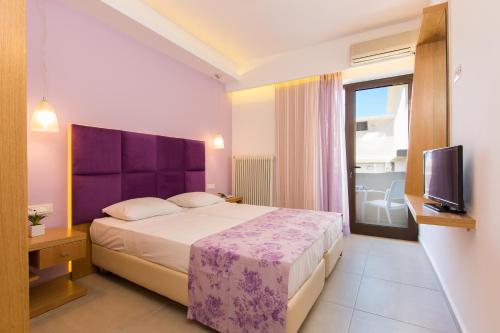 a hotel room with a bed and a tv at Eltina Hotel in Rethymno Town