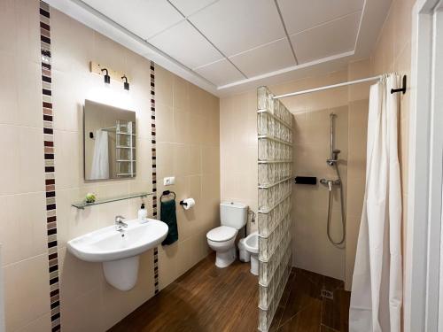 a bathroom with a sink and a toilet at Casa Rural La Travesía in Bolulla