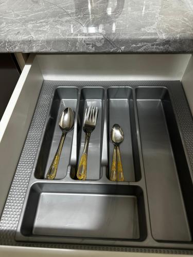 a kitchen sink with four forks and spoons at мини-отель Villa Sofia город Шымкент, проспект Тауке хана, жилой дом 37-2 этаж in Shymkent