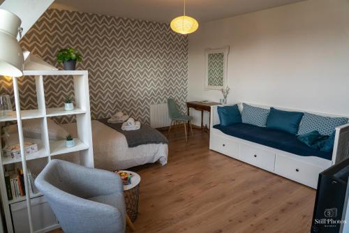 a living room with a bed and a couch at Les Beaux Jours, Tours in Tours