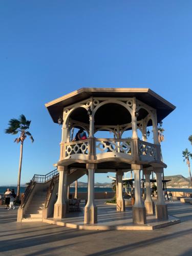 a building on a boardwalk with a palm tree at La Purisima Hotel in La Paz