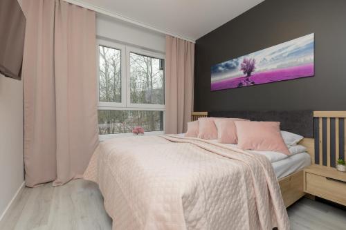 a bedroom with a bed and a tv on the wall at Dark Blue and Grey Apartment with Pastel Bedroom in Warsaw by Renters in Warsaw