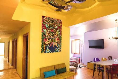 a dining room with a painting on the wall at Lisbon Art Stay Apartments Baixa in Lisbon