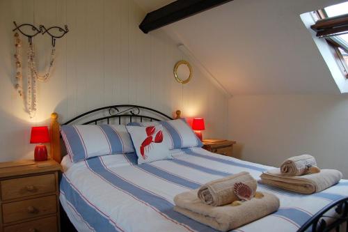 a bedroom with a large bed with towels on it at Cadair View Family Holiday Home in Tywyn