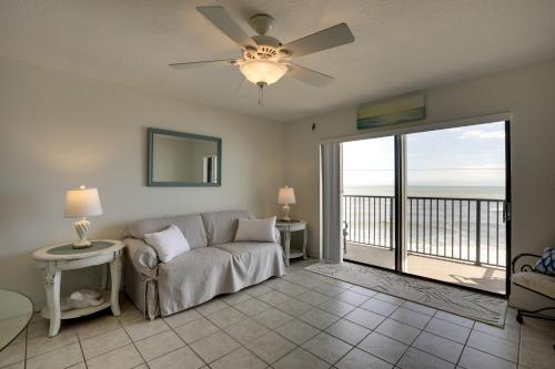a living room with a couch and a ceiling fan at Oceanfront Ormond Beach Condo Community Perks! in Ormond Beach