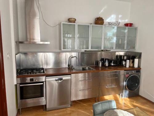 a kitchen with stainless steel cabinets and a sink at RETRO HOUSE in Braşov