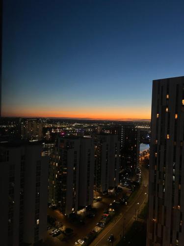 a view of a city at night with buildings at Luxury Apartment near Media City in Manchester