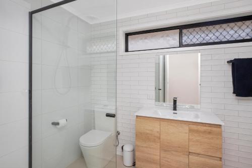 Baño blanco con aseo y lavamanos en Francis 31, en Port Macquarie