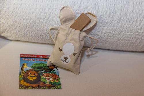 a bag sitting next to a book next to a bed at Urhof Chalet in Liesing