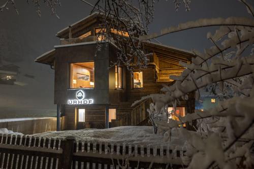 a log cabin in the snow at night at Urhof Chalet in Liesing