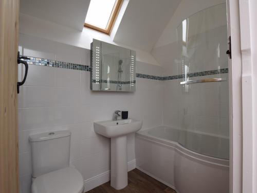a bathroom with a sink and a toilet and a tub at 2 Bed in Chulmleigh 72791 in Coldridge