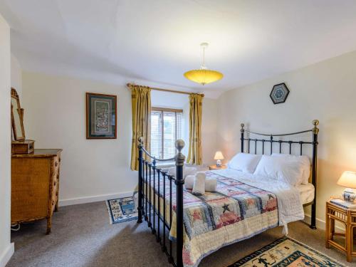 a bedroom with a bed and a window at 3 bed property in Bridport 75334 in Frome Vauchurch
