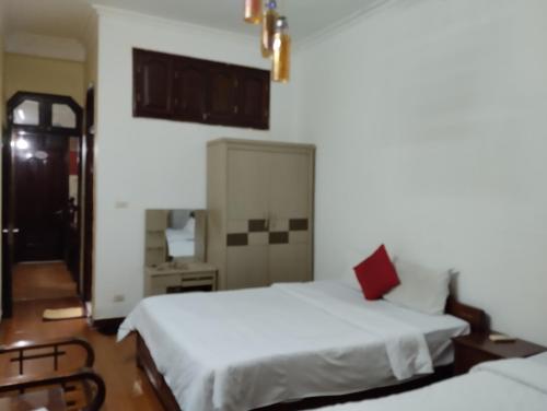a bedroom with two beds and a mirror at Holiday home in Hanoi