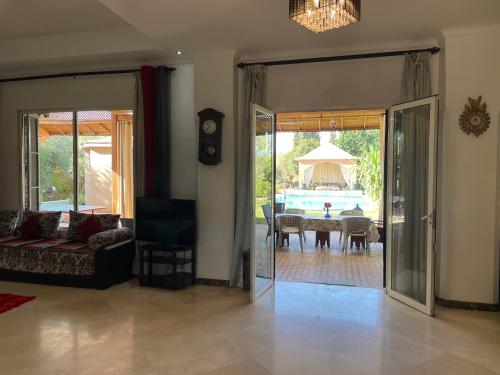 a living room with a door open to a dining room at Authentic Villa Ideal for 16+ guests in Marrakesh