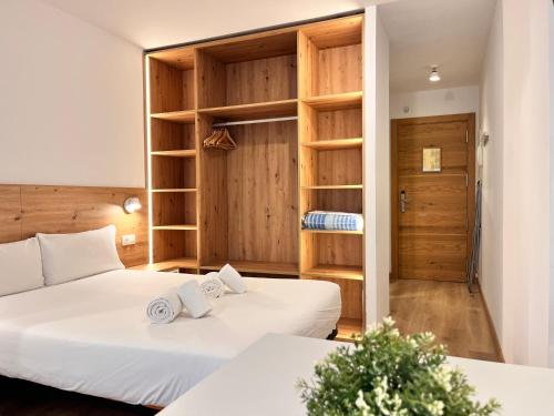 a room with two beds and a closet at Outdoor Apartaments - Spot in Andorra la Vella