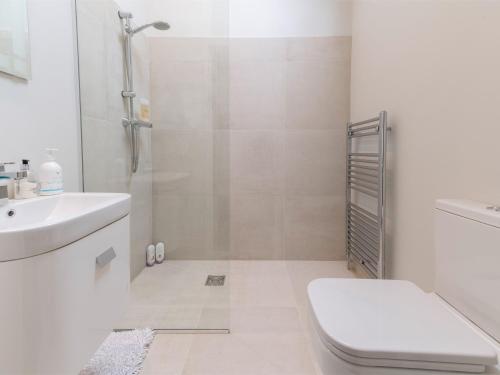 a bathroom with a shower and a toilet and a sink at 1 Bed in Harrogate HH055 in Harrogate