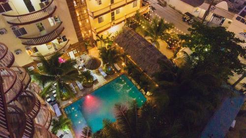 an overhead view of a swimming pool in a building at Tropical Palace Hotel in San Pedro