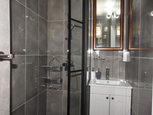 a bathroom with a shower and a sink at Belview Apartments in Belmont