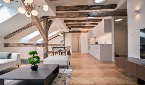 a living room with exposed beams and a table and chairs at Laurinska 1 Apartments in Bratislava