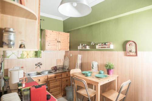 a small kitchen with a table and a sink at Urban Apartment in the Heart of Athens in Athens