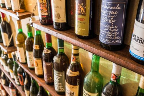 a bunch of wine bottles are lined up on a shelf at La Chicca B&B Siena in Siena
