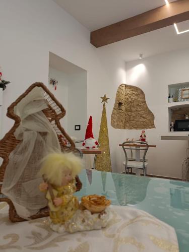 a doll sitting on a glass table in a room at B&B Borgo Sabelli - Costa dei Trabocchi in Casalbordino