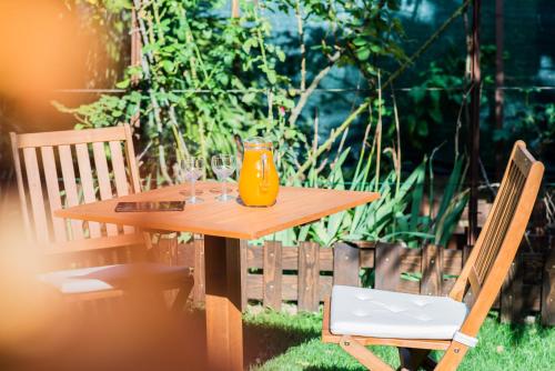 a wooden table with a glass of orange juice on it at La Chicca B&B Siena in Siena