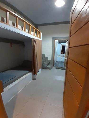 a room with bunk beds and a hallway at anik homestay & dormy Batukaras in Batukaras