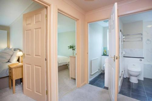 a bathroom with a toilet and a bed in a room at Western Court Sidmouth close to town and beach in Sidmouth