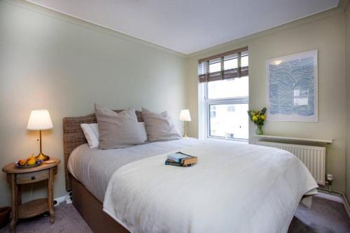 a bedroom with a large white bed and a window at Western Court Sidmouth close to town and beach in Sidmouth