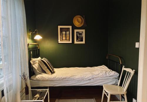 a bedroom with a bed in a green wall at Villa Sol Bed & Breakfast in Borgholm