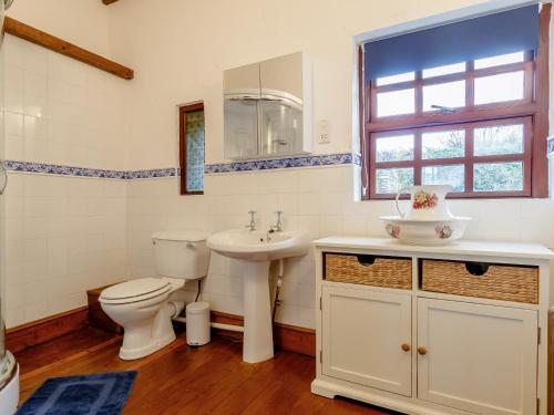 a bathroom with a toilet and a sink at 1 bed property in Gower 77980 in Penclawdd