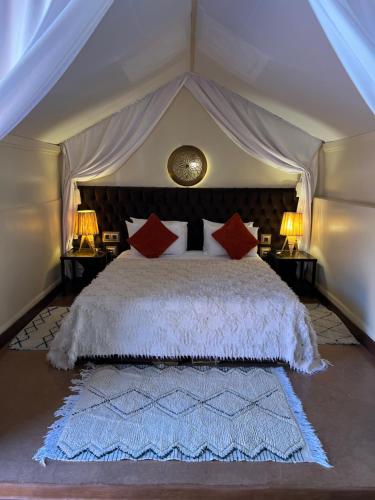 a bedroom with a large bed in a tent at Riad Des Arts in Marrakech