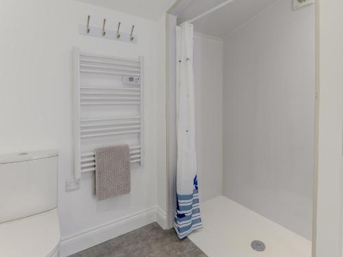 a white walk in closet with a glass door at 1 Bed in Weymouth 78865 in Weymouth