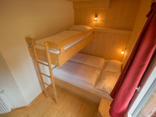 a bunk bed room with two bunk beds and a ladder at Chalet Klippitztörl 341 by Interhome in Klippitztorl