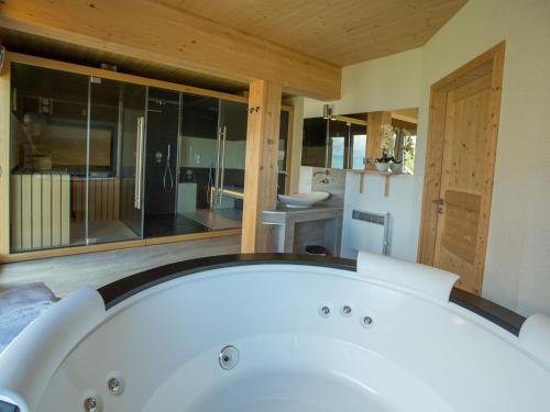 a large white bath tub in a bathroom at Chalet Klippitztörl 341 by Interhome in Klippitztorl