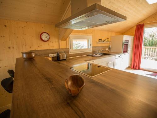 a large kitchen with a large wooden counter top at Chalet Klippitztörl 341 by Interhome in Klippitztorl