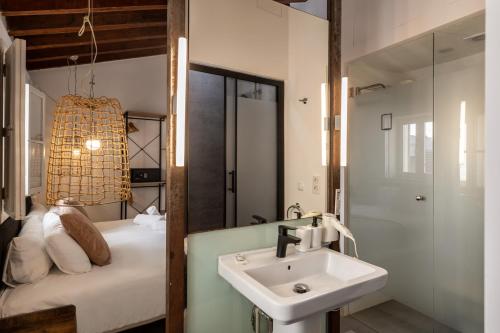 a bathroom with a sink and a bed with a mirror at Antiguo Brondo Selfcheck-in Smart Rooms in Palma de Mallorca