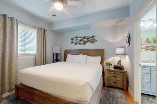 a bedroom with a large bed and a window at Sterling Breeze 1803 in Panama City Beach