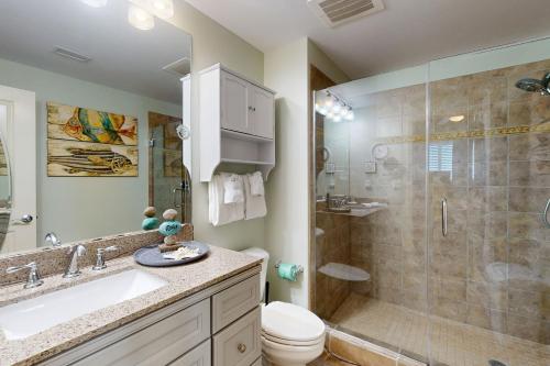 a bathroom with a shower and a sink and a toilet at Sterling Breeze 1803 in Panama City Beach