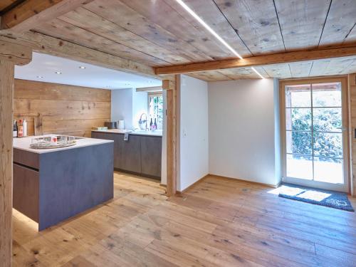 a kitchen with wooden floors and a counter in a room at Holiday Home Im Rach by Interhome in Saas