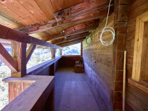 a hallway in a cabin with wooden walls and wooden floors at Holiday Home Im Rach by Interhome in Saas