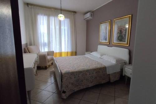 a bedroom with a bed and a living room at Casa vacanze Milazzo in Milazzo