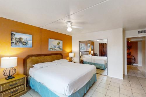 a bedroom with a large bed and a mirror at Gulfview I #312 in South Padre Island