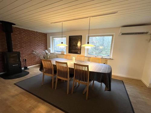 a dining room with a table and four chairs at Holiday Home Geske - all inclusive - 3-2km from the sea in Sealand by Interhome in Eskebjerg