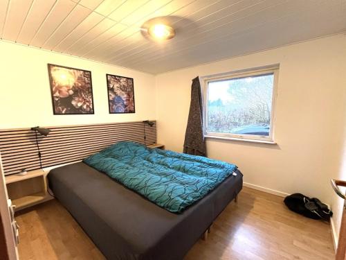 a bedroom with a bed in a room with a window at Holiday Home Geske - all inclusive - 3-2km from the sea in Sealand by Interhome in Eskebjerg